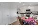 Dining area with white cabinets, stainless steel appliances and hardwood floors at 2572 Averland Loop, North Port, FL 34287
