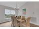 Bright dining room features a chandelier, beach painting, and decorative window blinds at 2572 Averland Loop, North Port, FL 34287