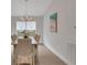 Dining room with hardwood floors, pendant lighting, and bright windows at 2572 Averland Loop, North Port, FL 34287