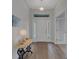 Inviting foyer with natural light, wood-look tile flooring, and views of the front door at 2572 Averland Loop, North Port, FL 34287