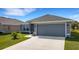 Beautiful home with a well-kept lawn, a spacious driveway and modern exterior lighting at 2572 Averland Loop, North Port, FL 34287