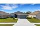 Well-maintained single-Gathering home featuring a gray exterior, gray roof and a spacious driveway at 2572 Averland Loop, North Port, FL 34287