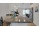 Open kitchen with granite countertops, a center island with seating, and stainless steel appliances at 2572 Averland Loop, North Port, FL 34287