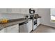 Bright kitchen with white cabinets, stainless steel appliances and granite countertops at 2572 Averland Loop, North Port, FL 34287
