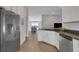 Modern kitchen featuring stainless steel appliances, granite countertops, and wood-look flooring at 2572 Averland Loop, North Port, FL 34287