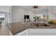 Modern kitchen island featuring granite countertops and stainless steel sink with faucet at 2572 Averland Loop, North Port, FL 34287