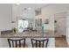 Spacious kitchen featuring granite countertops, stainless steel sink, and white cabinetry at 2572 Averland Loop, North Port, FL 34287