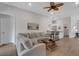 Spacious living room with hardwood floors, open layout, and views to other living spaces at 2572 Averland Loop, North Port, FL 34287