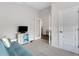 Bright room with futon couch and TV, connecting to another room with glass door at 2572 Averland Loop, North Port, FL 34287