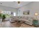 Bright living room features a large sectional sofa with decorative pillows and plenty of natural light at 2572 Averland Loop, North Port, FL 34287