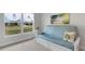 Comfortable living room with futon, tropical art, and neighborhood view at 2572 Averland Loop, North Port, FL 34287