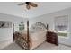 Comfortable main bedroom features large windows, a ceiling fan, and four-poster bed at 2572 Averland Loop, North Port, FL 34287