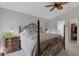 Well-lit main bedroom with a four-poster bed and view to the ensuite bath at 2572 Averland Loop, North Port, FL 34287