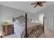 Spacious main bedroom with a four-poster bed and access to the ensuite bathroom and walk-in closet at 2572 Averland Loop, North Port, FL 34287
