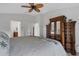 Large bedroom with a four-poster bed and dark wood dressers at 2572 Averland Loop, North Port, FL 34287