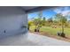 Covered patio with a view of the landscaped backyard and lush greenery at 2572 Averland Loop, North Port, FL 34287