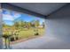 Covered patio offering scenic views of the green backyard and mature trees at 2572 Averland Loop, North Port, FL 34287
