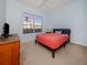 Cozy bedroom with a window and furnishings that create a relaxing atmosphere at 2602 Ravinia Cir # 2602, Venice, FL 34292