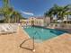 Sparkling community pool surrounded by lounge chairs, palm trees and well maintained landscaping at 2602 Ravinia Cir # 2602, Venice, FL 34292