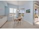 Breakfast nook boasts a round table, light fixture and bright natural light from the backyard at 2602 Ravinia Cir # 2602, Venice, FL 34292