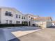 Exterior view showing a stucco home with a red tile roof and parking area at 2602 Ravinia Cir # 2602, Venice, FL 34292