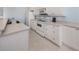 Bright and airy kitchen featuring white appliances, neutral countertops, and ample cabinet space at 2602 Ravinia Cir # 2602, Venice, FL 34292