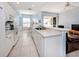 Bright kitchen with white cabinetry, modern appliances, breakfast bar and a view into the dining area at 2602 Ravinia Cir # 2602, Venice, FL 34292