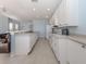 Spacious kitchen featuring modern white cabinetry, ample counter space, and stainless steel appliances at 2602 Ravinia Cir # 2602, Venice, FL 34292