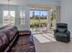 Bright living room with large windows, tile flooring, and a view of the outside patio at 2602 Ravinia Cir # 2602, Venice, FL 34292