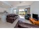 Open floor plan with a living room, kitchen, and a screened patio with a view of the golf course at 2602 Ravinia Cir # 2602, Venice, FL 34292