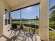 Screened in patio with a picturesque view of the pond and landscaping at 2602 Ravinia Cir # 2602, Venice, FL 34292