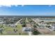 Expansive aerial view of a residential neighborhood with lush greenery and a tranquil pond in the distance at 2783 Biscayne Dr, North Port, FL 34287