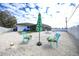 The home's backyard has an umbrella, lawn furniture, and lots of space for entertaining guests at 2783 Biscayne Dr, North Port, FL 34287