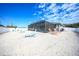 The white stone backyard has assorted lawn furniture and plenty of room for entertaining or relaxing at 2783 Biscayne Dr, North Port, FL 34287