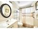 Bathroom features a vanity, mirror, shower with curtain, toilet, and wall art at 2783 Biscayne Dr, North Port, FL 34287