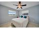 Cozy bedroom features a ceiling fan, tile floors, and sunny windows for a bright and airy feel at 2783 Biscayne Dr, North Port, FL 34287