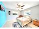 Bright bedroom features tile floors, a ceiling fan, wall-mounted TV, and multiple windows providing natural light at 2783 Biscayne Dr, North Port, FL 34287