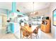 Open concept dining area with white cabinets, a breakfast bar, and sliding glass doors to the lanai at 2783 Biscayne Dr, North Port, FL 34287