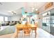 Open concept dining area with views into the kitchen and a lanai with a ceiling fan at 2783 Biscayne Dr, North Port, FL 34287