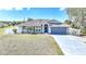 Charming single-story home with a well-maintained lawn and a two-car garage and welcoming front entrance at 2783 Biscayne Dr, North Port, FL 34287