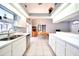 Bright kitchen with white cabinets, stainless appliances, adjacent dining area, and views of the lanai at 2783 Biscayne Dr, North Port, FL 34287