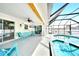 Relaxing screened-in pool area with patio seating, a ceiling fan, and views of the shimmering pool and spa at 2783 Biscayne Dr, North Port, FL 34287