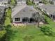 Aerial view of a private backyard with a screened-in lanai and lush green lawn at 29692 Niagara Ct, Englewood, FL 34223