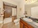 Clean bathroom with a shower-tub combo, modern vanity, and tiled floors at 29692 Niagara Ct, Englewood, FL 34223
