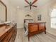 Tranquil bedroom with wood flooring, ceiling fan, and dresser at 29692 Niagara Ct, Englewood, FL 34223