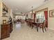 Open-concept floor plan with dining area adjacent to living room with large windows at 29692 Niagara Ct, Englewood, FL 34223