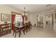 Elegant dining room with tile flooring, chandelier, and large window for natural light at 29692 Niagara Ct, Englewood, FL 34223
