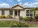 Charming front entrance with decorative door, pathway, well-manicured lawn and mature landscaping at 29692 Niagara Ct, Englewood, FL 34223