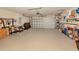Spacious two car garage featuring ample room for storage, garage door opener, and bright lighting at 29692 Niagara Ct, Englewood, FL 34223