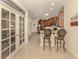 Bright kitchen with counter seating and access to the living room through beautiful french doors at 29692 Niagara Ct, Englewood, FL 34223